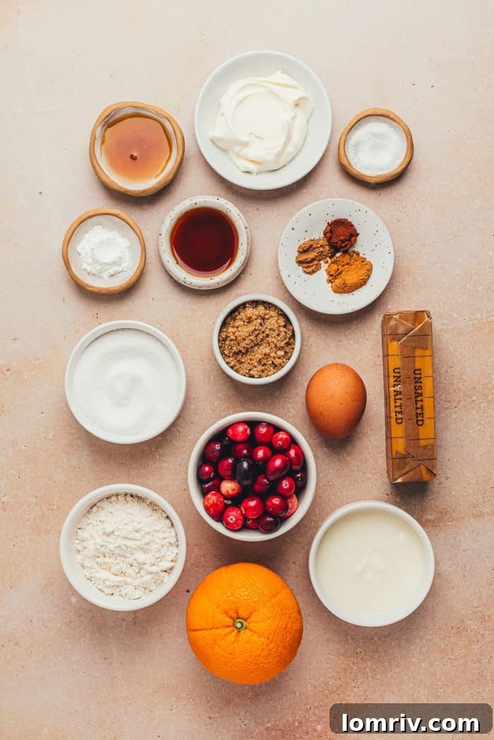 Various bowls holding precisely measured ingredients for making cranberry crumb cake, neatly arranged.