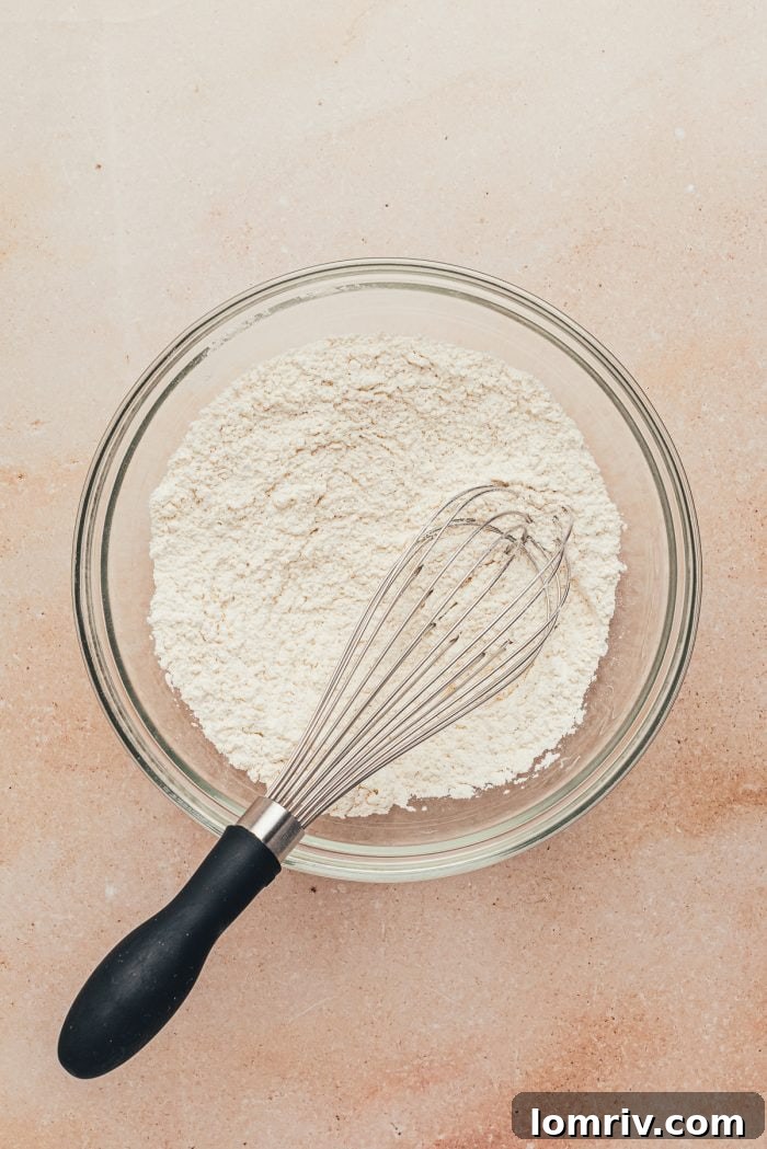 A mixing bowl with whisked dry ingredients (flour, salt, baking powder) for the cake batter.