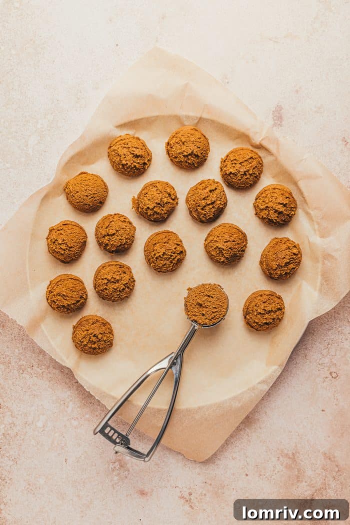 Scoops of gingerbread thumbprint cookie dough on a plate.