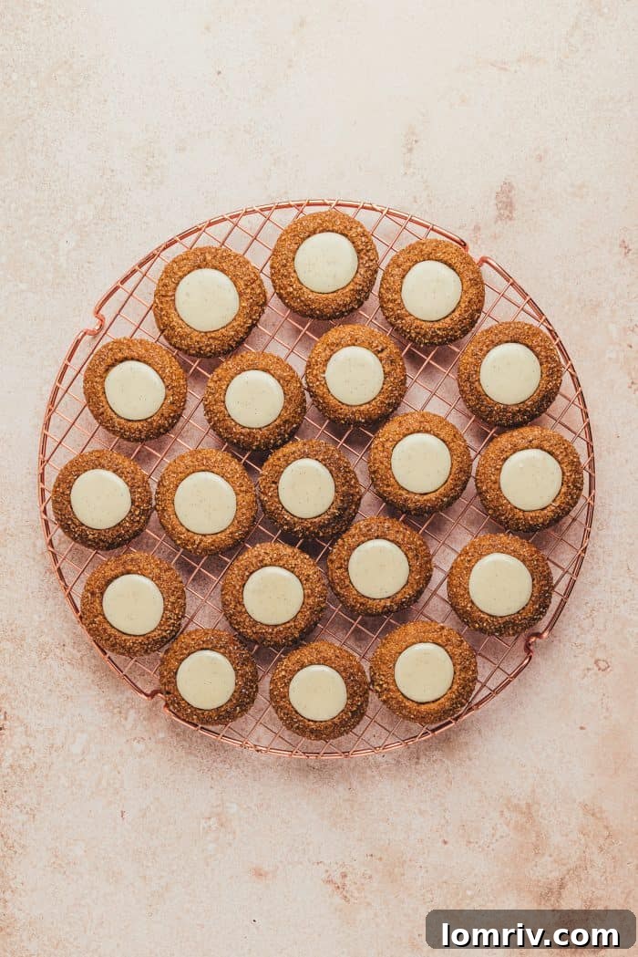 The filled thumbprint cookies cooling on a cooling rack.