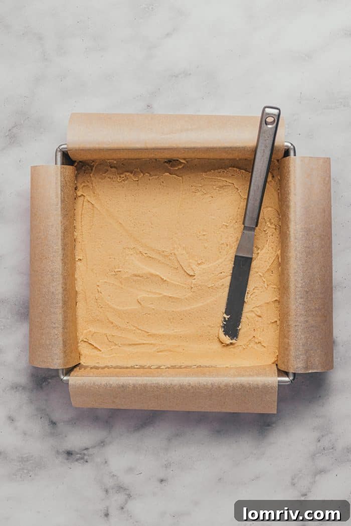 A square baking pan with unbaked sugar cookie bars.