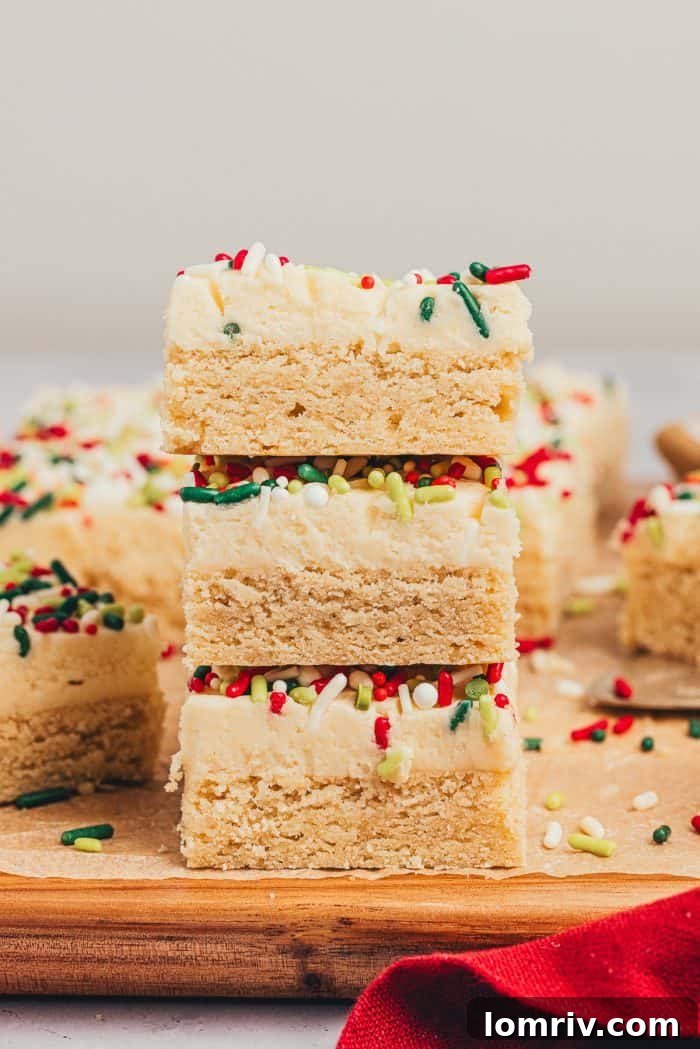A stack of sugar cookie bars on a wooden cutting board.