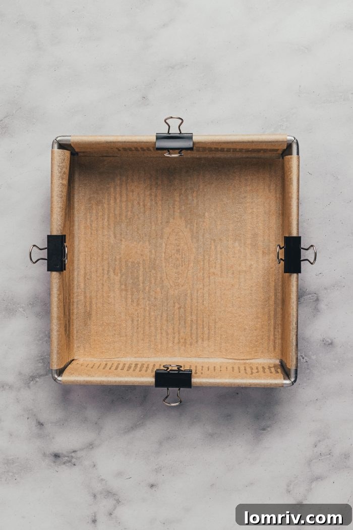 A square baking pan  with parchment paper.