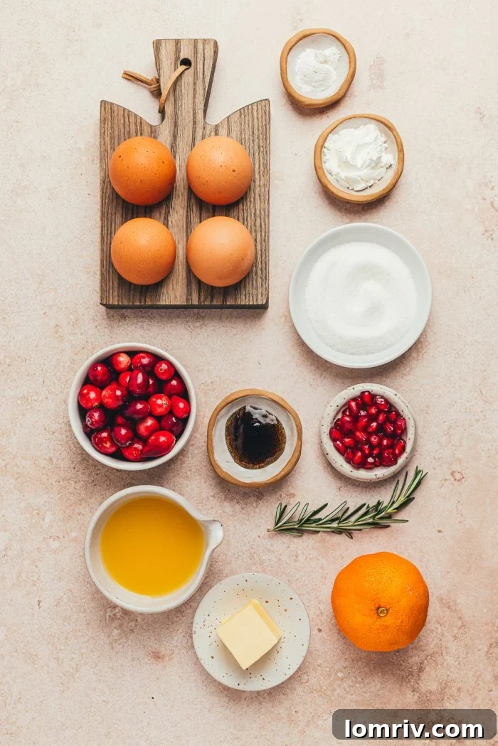 An array of fresh ingredients for mini pavlovas, including cranberries, eggs, sugar, butter, and orange juice, laid out in separate bowls.