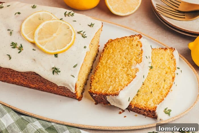 A lemon Thyme cake loaf, perfectly sliced, is attractively arranged on a white platter, ready for serving.