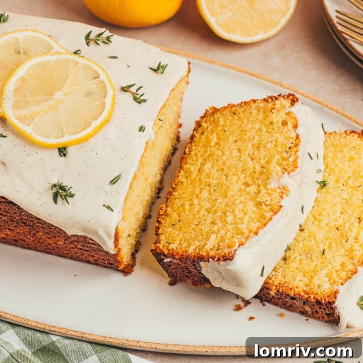 A lemon Thyme cake loaf cut into slices on a platter.