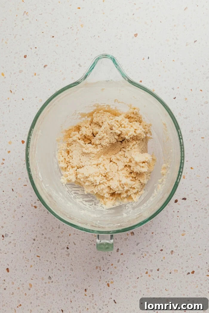 The coconut flakes filling mixed together in a glass mixing bowl.