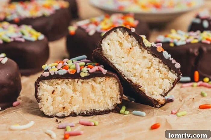 A few homemade chocolate Easter eggs scattered on parchment paper and one egg is split in half. 