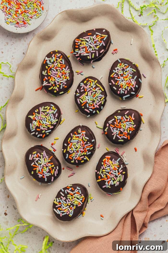 A few homemade chocolate Easter eggs scattered on a plate.