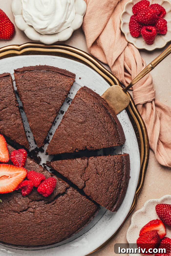 A freshly baked chocolate ricotta cake, skillfully cut into individual slices and arranged on a platter alongside a medley of colorful fresh fruit, ready to be enjoyed.