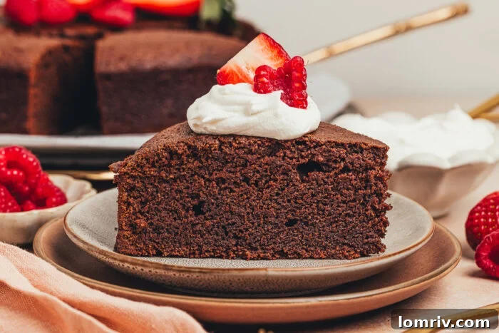 An artfully composed shot of a single slice of chocolate ricotta cake, crowned with whipped cream and fresh berries, on a elegant plate, ready to be enjoyed.