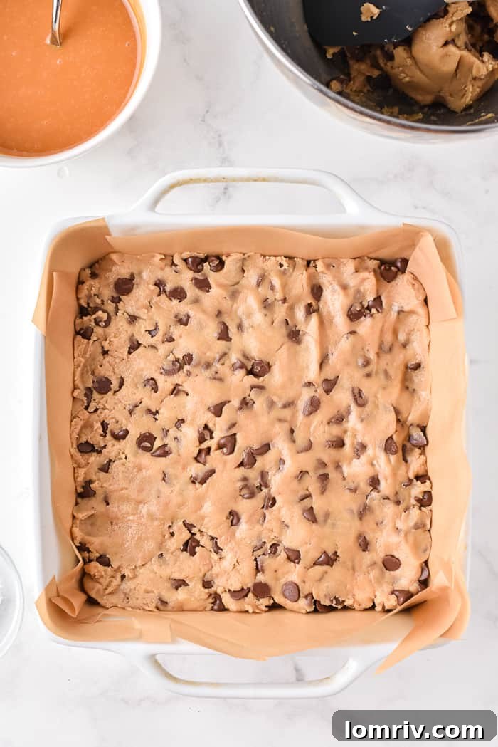 Spreading cookie dough into baking pan