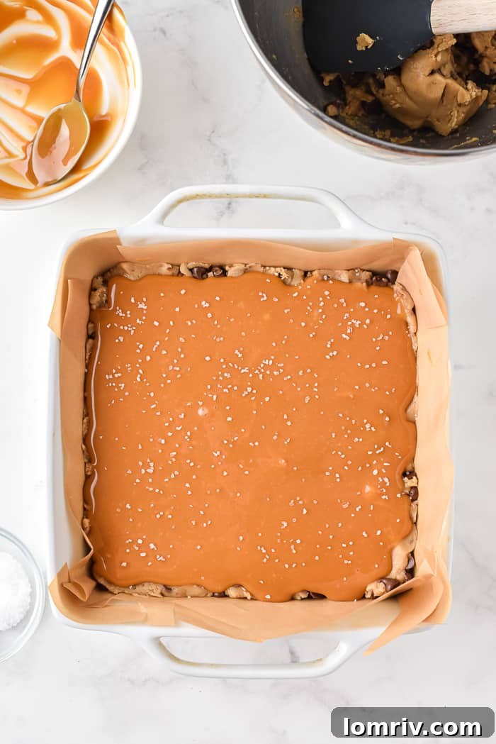 Pouring melted caramel over cookie dough