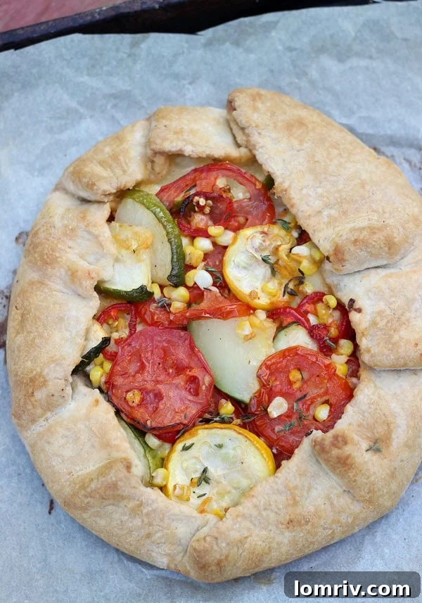 Delicious and rustic summer vegetable galette with a golden, flaky crust filled with colorful veggies