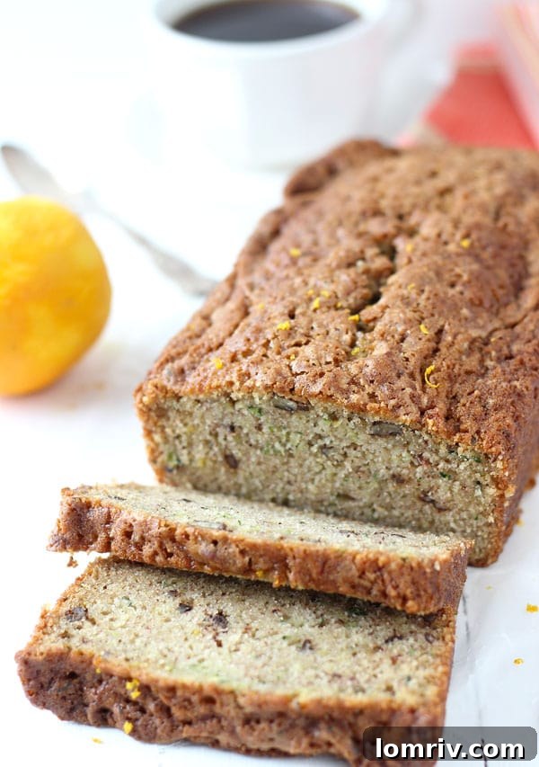 Slices of moist Orange Zucchini Bread on a cutting board, ready to be enjoyed