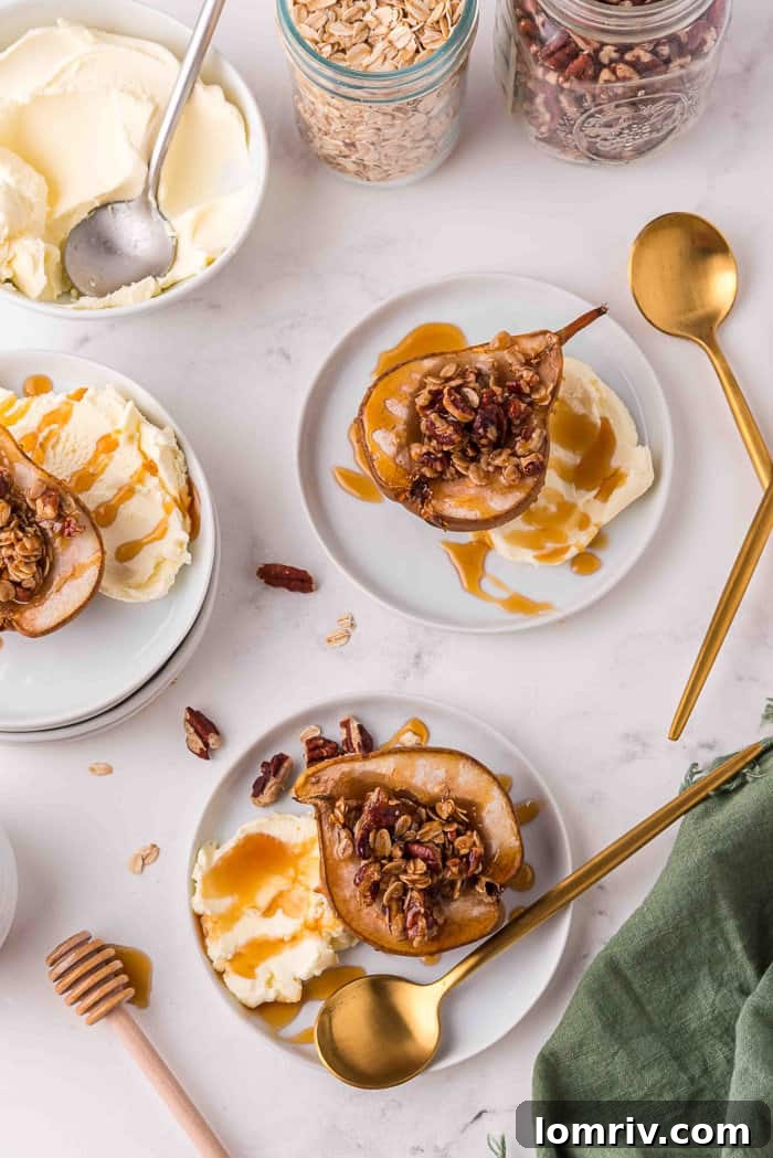 Close-up of baked pear halves topped with mascarpone and honey on a white plate
