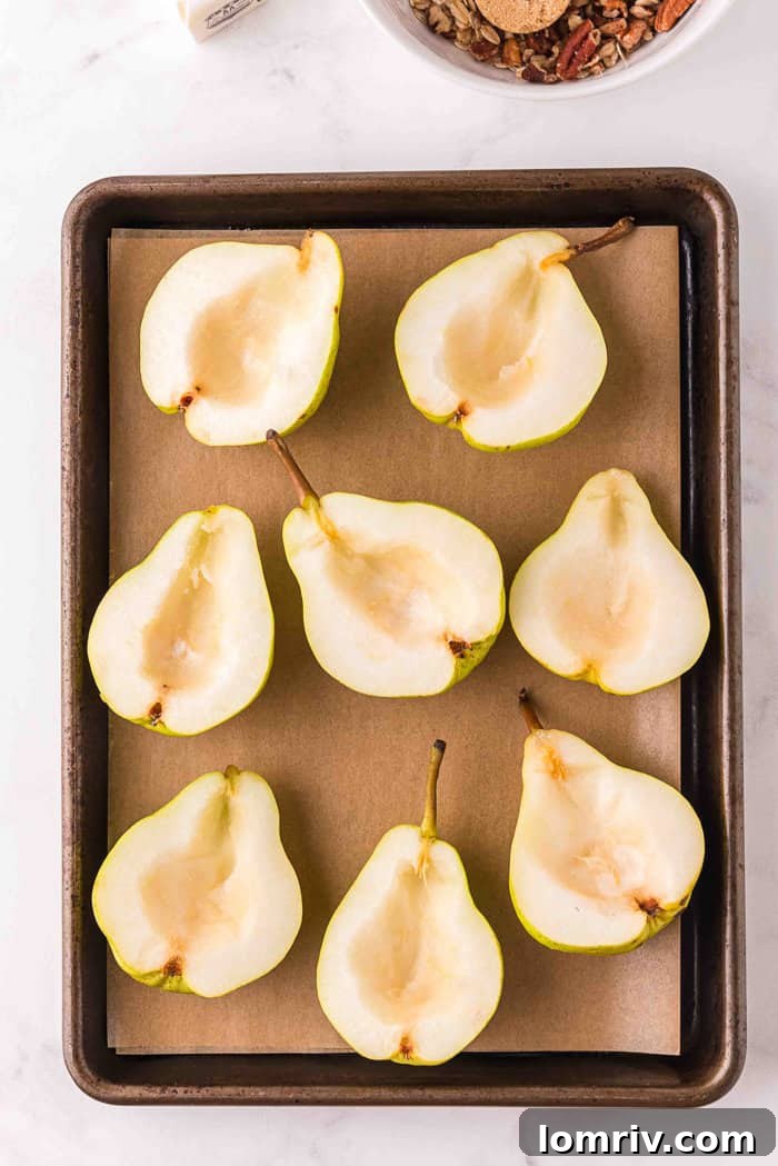 Pears cut in half and cored, placed on a baking sheet, cut side up