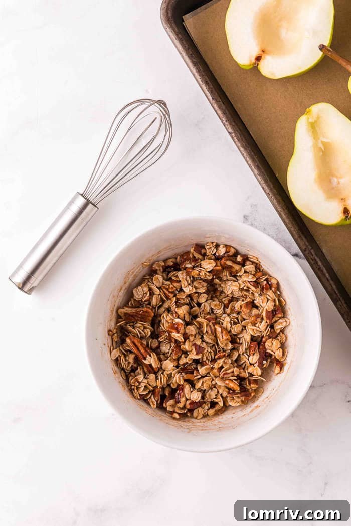 Bowl showing wet and dry ingredients mixed for oat crumble, forming clumps