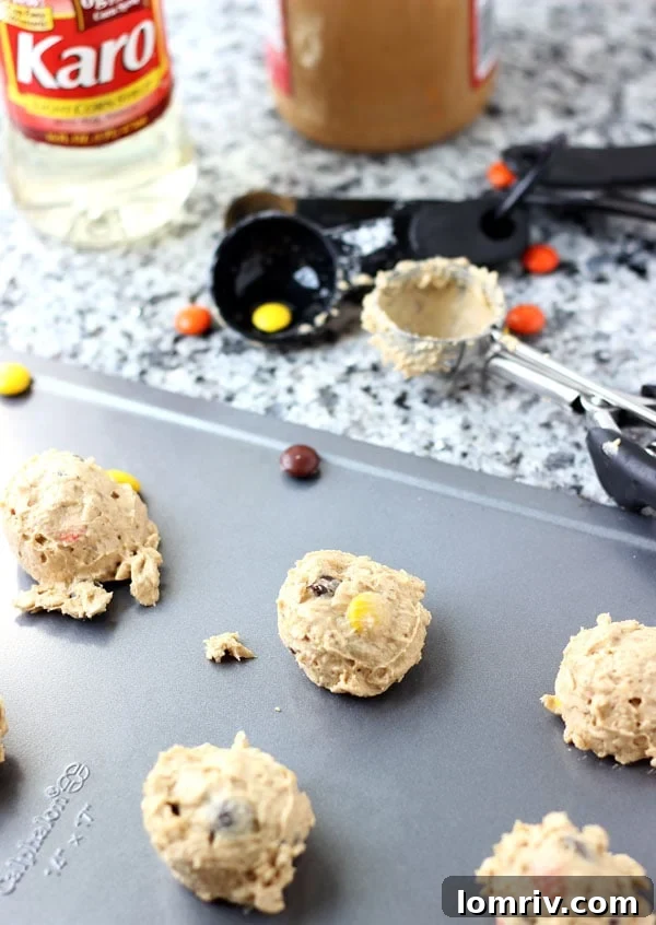 Close-up of a stack of Halloween Monster Cookies, highlighting their chewy texture and colorful Reese's Pieces