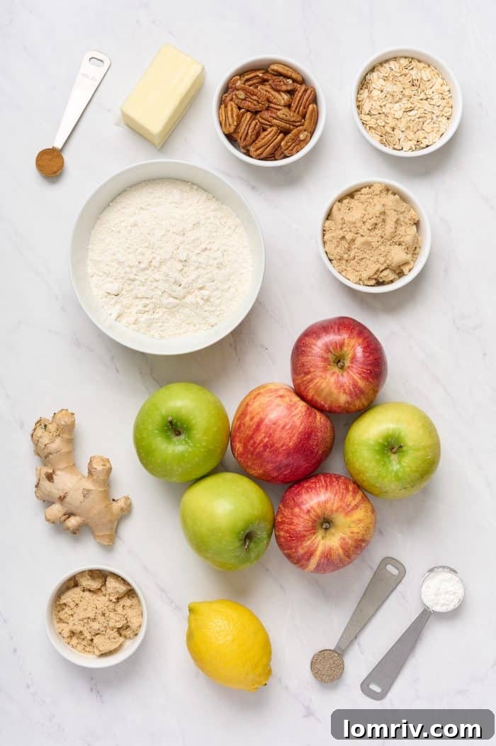 A flat lay of all the fresh ingredients needed to bake an apple cardamom crisp, including apples, spices, butter, and oats.