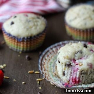 Raspberry Chocolate Freekeh Muffins, a healthy and hearty breakfast option, displayed on a wooden board.