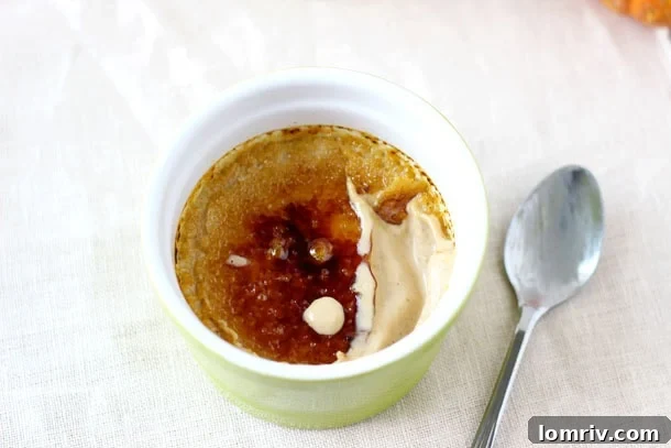 Silky Smooth Pumpkin Maple Creme Brulee with a perfectly caramelized top, garnished with a sprinkle of cinnamon.