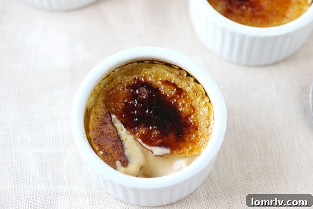 Four ramekins of Pumpkin Maple Creme Brulee, perfectly caramelized and ready to serve.