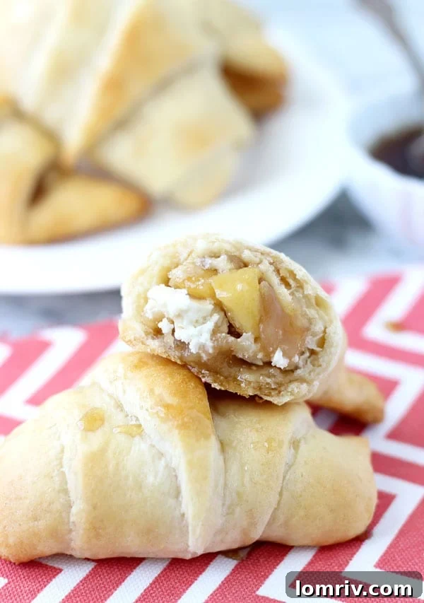 Close-up photograph of freshly baked Caramelized Apples and Goat Cheese Crescents, showcasing their golden crust and enticing filling