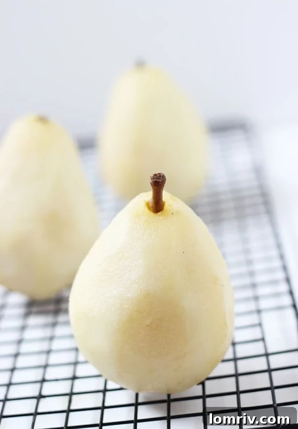 Three ramekins of Spiced Poached Pear Crumble, golden brown and ready to serve