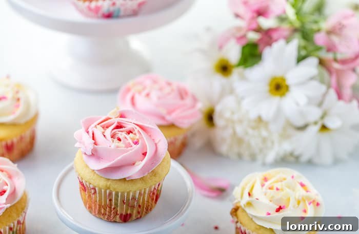 Close-up of a perfectly frosted White Chocolate Rose Cupcake, showcasing the elegant white chocolate and rose infused buttercream.