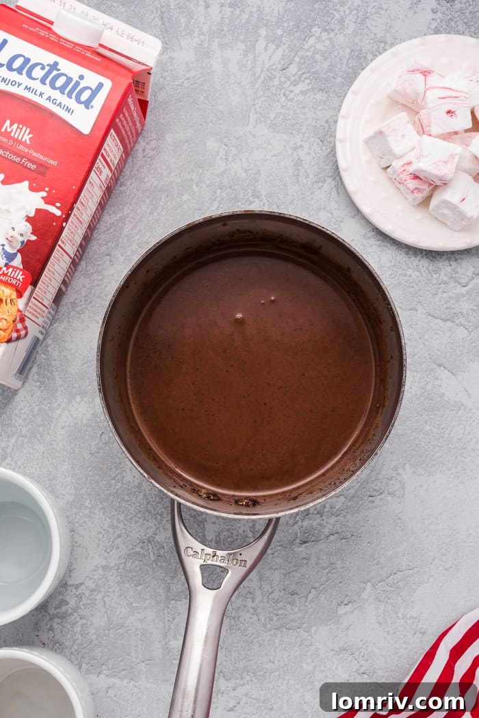 Lactose-free milk and dark chocolate being prepared for hot cocoa