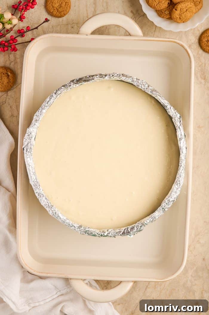 Cheesecake filling poured into a springform pan, set in a water bath.