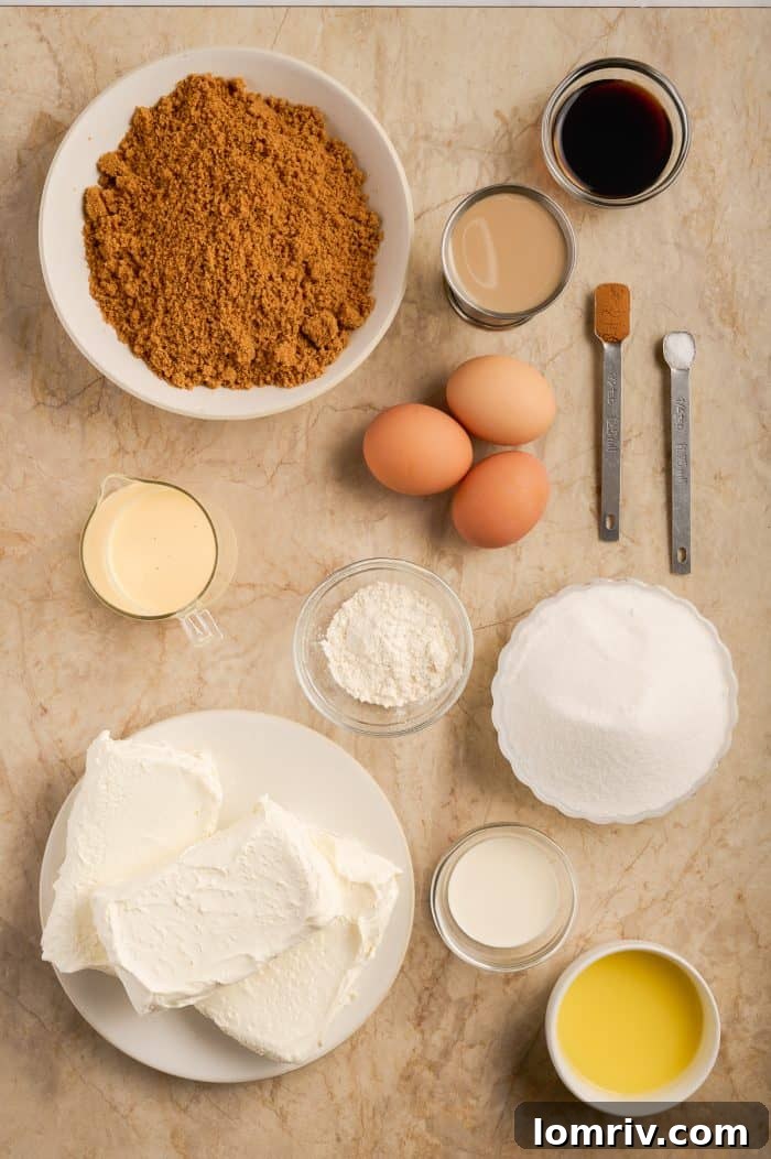 Key ingredients for making eggnog cheesecake laid out on a surface.