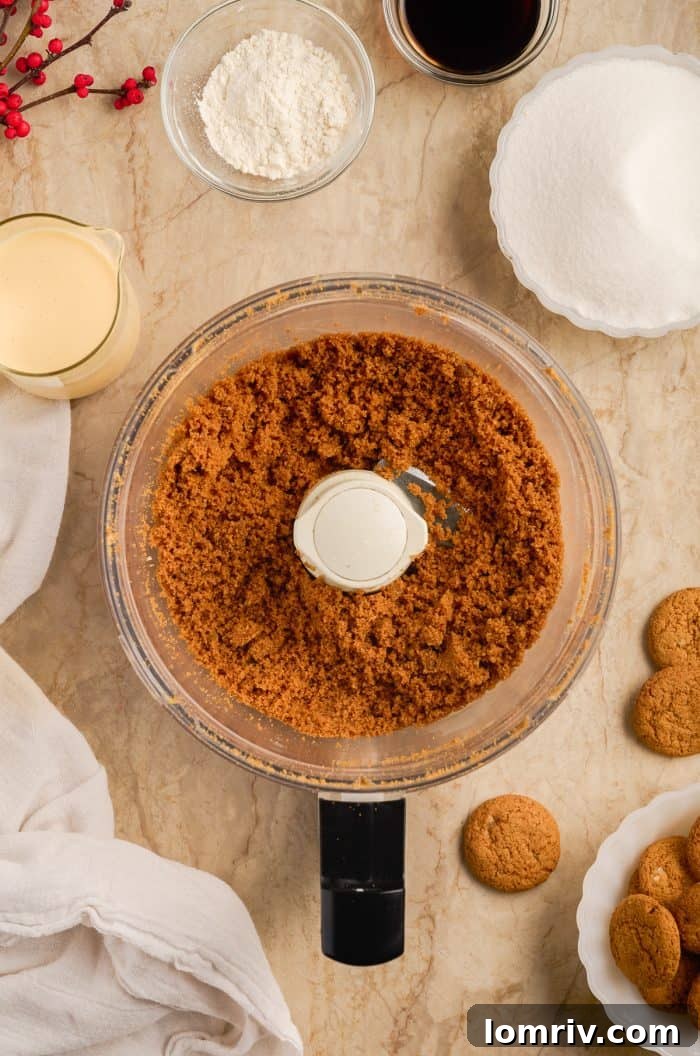 Gingersnap crust ingredients being processed in a food processor.