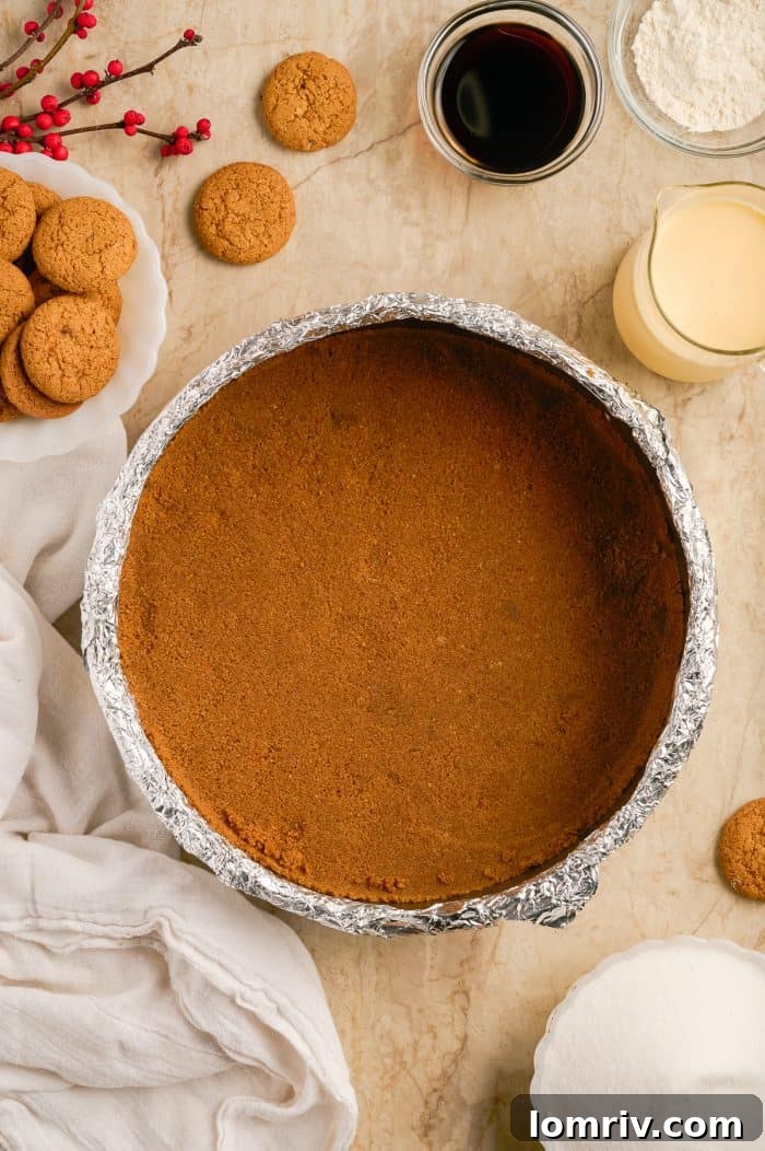 The gingersnap crust pressed into a springform pan, ready for baking.
