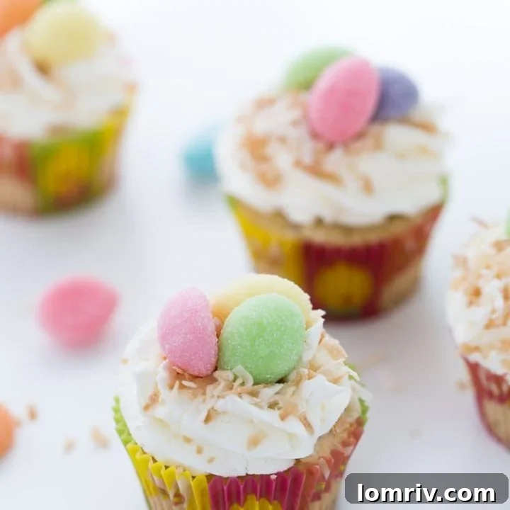 Close-up of a festive coconut bird nest cupcake with mini chocolate eggs.