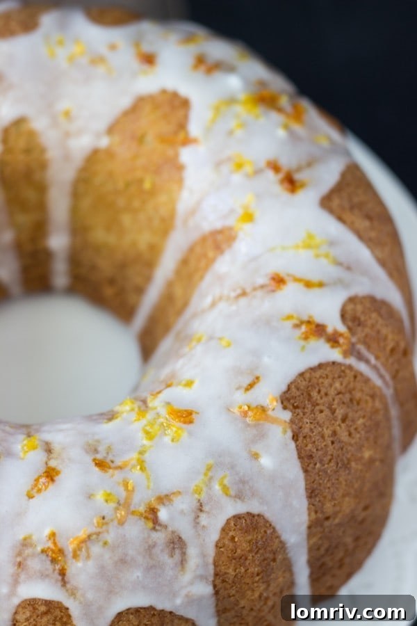 Grapefruit-Orange-Pound Cake presented as a whole bundt cake on a wire rack, cooling and showcasing its intricate design.