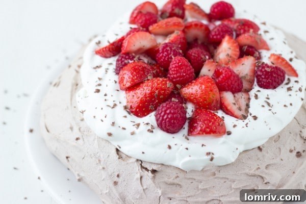 Chocolate Pavlova layered with fresh strawberries and whipped cream