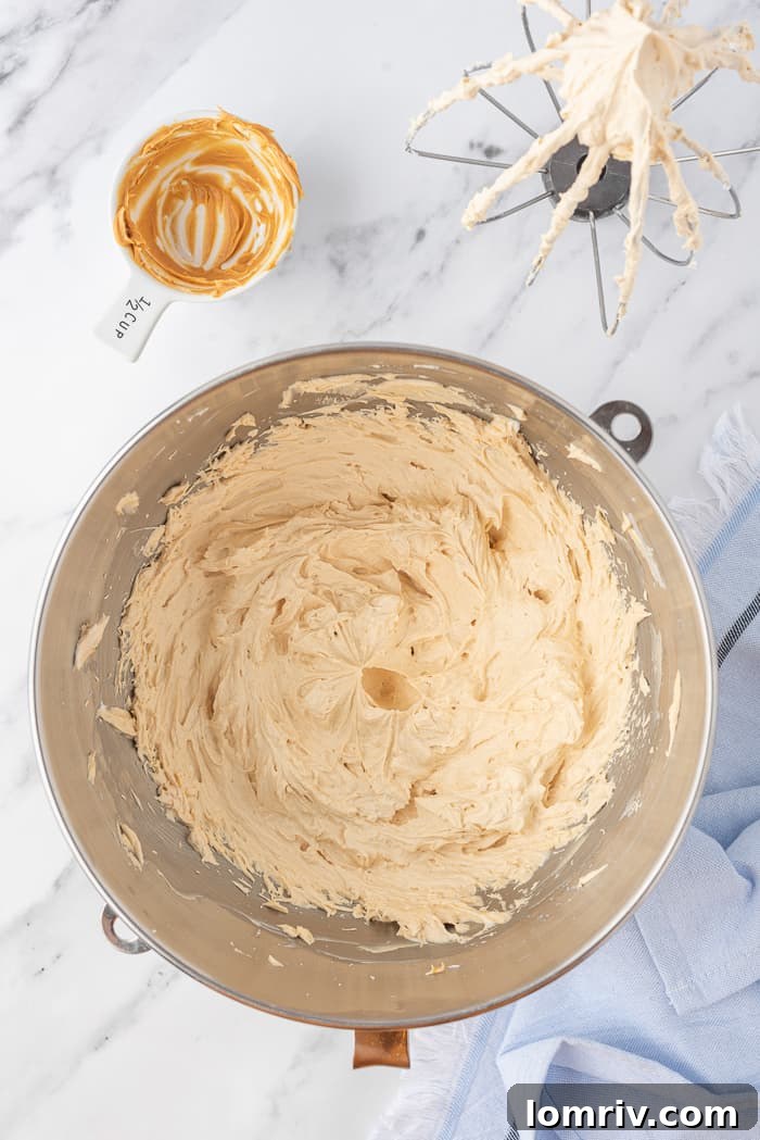 Peanut butter buttercream being mixed for final consistency