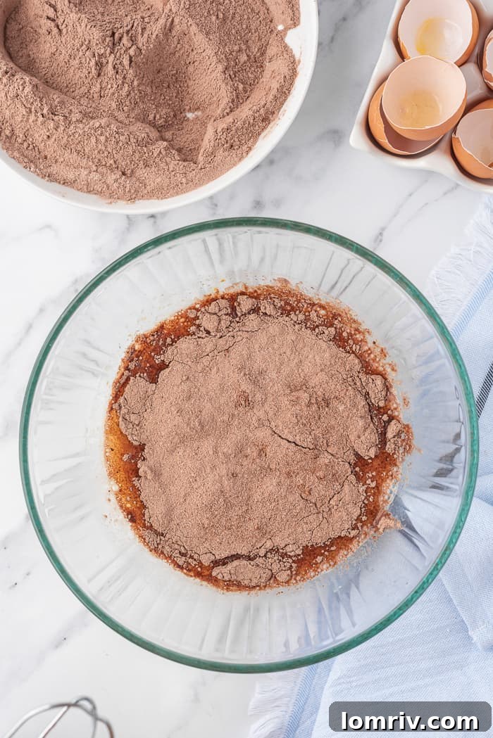 Dry ingredients being added to wet ingredients for chocolate cupcakes