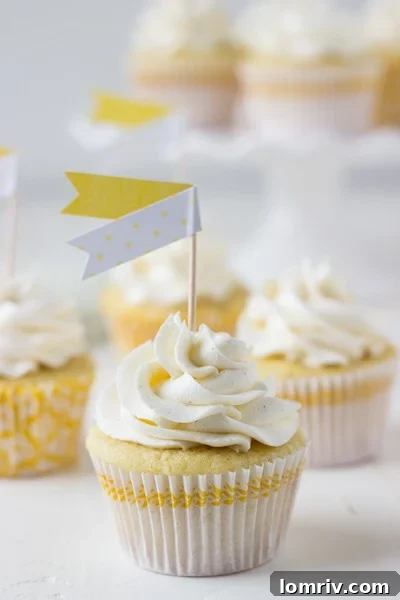 Three Meyer Lemon Rosemary Cupcakes beautifully frosted on a serving plate