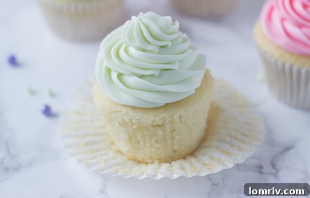 Delicious Key Lime Cupcakes on a rustic wooden surface, ready to be enjoyed.