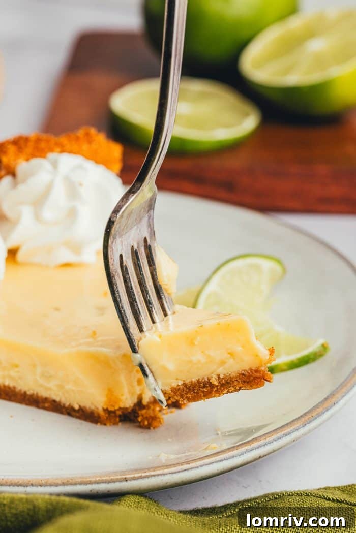 A slice of Key Lime Pie, freshly cut and served on a plate, ready to be savored.