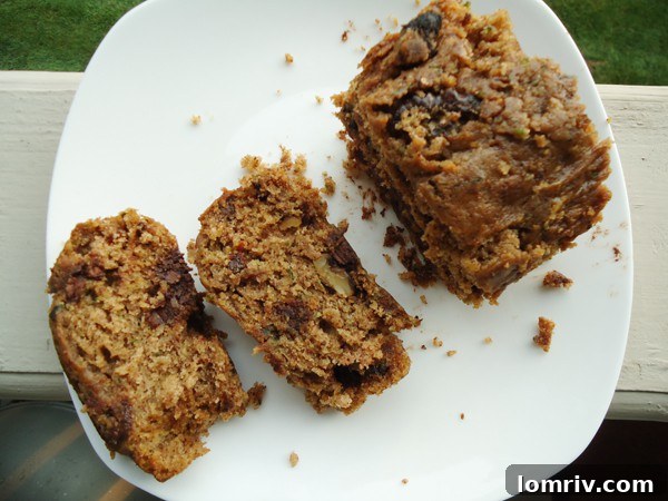 A close-up shot of a slice of Zucchini Chocolate Chip Bread, highlighting its moist crumb and rich chocolate chips
