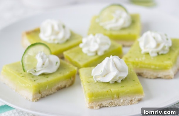 A tray of freshly baked Coconut Lime Bars, cooling on a wire rack, ready for their final topping.