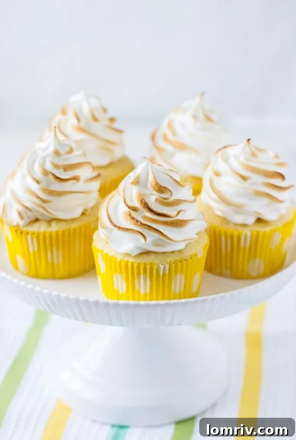 lemon meringue cupcakes ~ fluffy lemon cupcakes filled with lemon curd and topped with a cloud of marshmallow frosting.