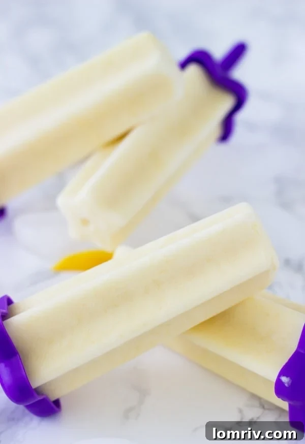 Refreshing homemade mango yogurt popsicles, a healthy summer treat made with Greek yogurt and coconut milk.