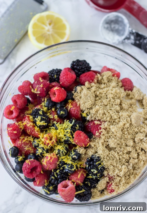 Bowl of prepared Mixed Berry Pie filling, showing berries coated in sugar and spices, ready for the crust.