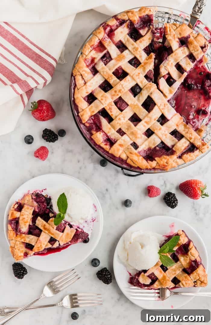 Freshly baked Mixed Berry Pie on a cooling rack, steam gently rising, crust golden brown and filling bubbly.