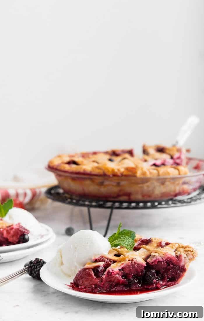 A full Mixed Berry Pie, artfully photographed and ready for serving, highlighting its homemade charm.